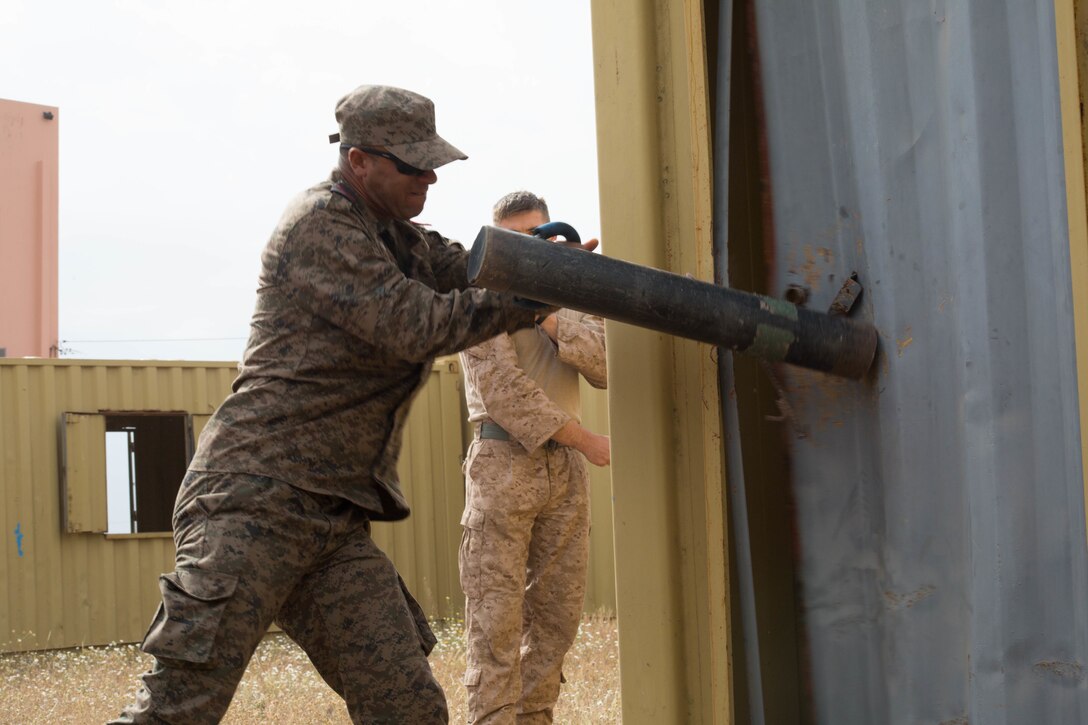 A member of the Tunisian Army Quick Reaction Force breaks down a door during Exercise African Lion 2018, in Tifnit, Morocco, April 20, 2018. African Lion is an annual, multinational, joint-force exercise improving interoperability between participating nations. (U.S. Marine Corps photo by Lance Cpl Tessa D. Watts)