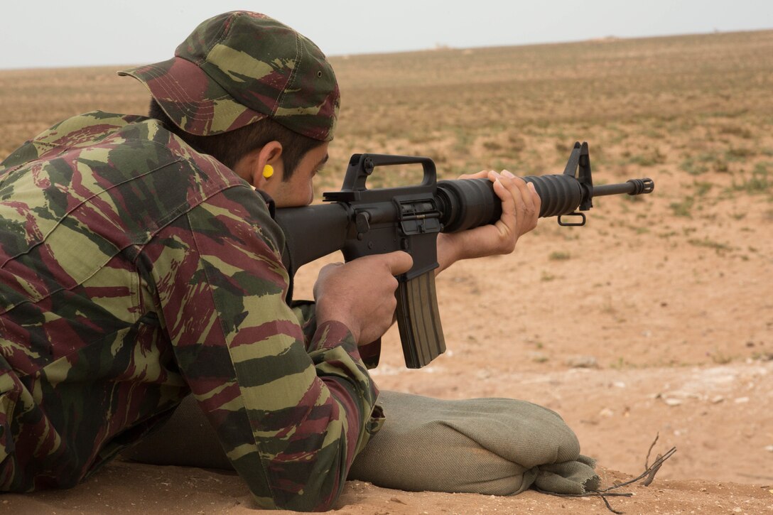 A member of the Gendarmerie aims down the iron sight of the M16A4 service rifle at the shooting range during Exercise African Lion 2018, in Tifnit, Morocco, April 20, 2018. African Lion is an annual, joint-force exercise improving interoperability between participating nations. African Lion is an annual, multinational, joint-force exercise improving interoperability between participating nations. (U.S. Marine Corps photo by Lance Cpl Tessa D. Watts)
