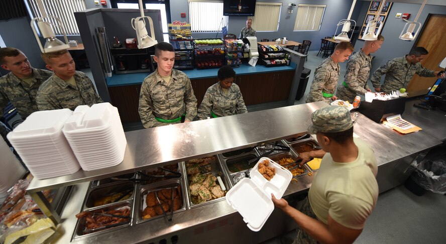 Airman serving food.