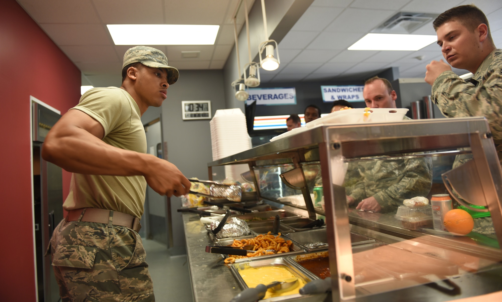 Airman serves food.