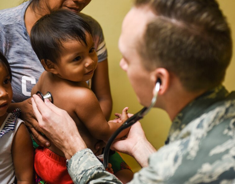 U.S. Air Force Capt. Charles Hutchings, 346th Expeditionary Medical Operations Squadron pediatrician, checks the heartbeat of a child in Meteti, Panama, April 17, 2018. Hutchings was part of an Embedded Health Engagement Team, which gave him a unique learning experience by submerging him into local clinics. The team was participating in Exercise New Horizons 2018, which will assist communities throughout Panama by providing medical assistance and building facilities such as schools, a youth community center and a women’s health ward. (U.S. Air Force photo by Senior Airman Dustin Mullen)