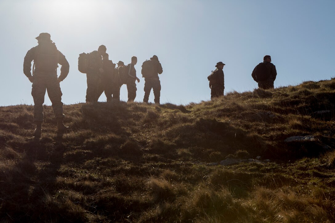 Marines and sailors with 4th Air Naval Gunfire Liaison Company, Force Headquarters Group, pause at the top of a hill to check their azimuth during a land navigation exercise in Durness, Scotland, April 30, 2018. 4th ANGLICO is in Scotland to take part in Joint Warrior 18-1, an exercise that furthers their readiness and effectiveness in combined arms integration, small unit tactics and land navigation. This training aims at improving their capabilities and combat effectiveness and ensures they're ready to fight tonight.