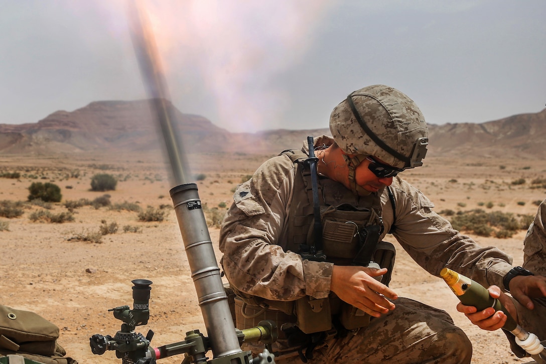 A Marine fires an M224A1 60 mm mortar system.