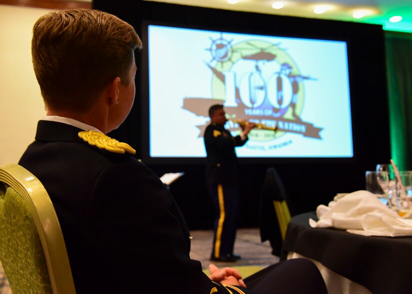 U.S. Army Col. Beth Behn, 7th Transportation Brigade (Expeditionary) commander, watches a member of the U.S. Army 392nd Army Band Jazz Combo perform at the Fort Eustis 100th Anniversary Gala in Newport News, Virginia, April 28, 2018. The event welcomed local officials to take part in celebrating 100 years of community partnership. (U.S. Air Force photo by Airman 1st Class Monica Roybal)