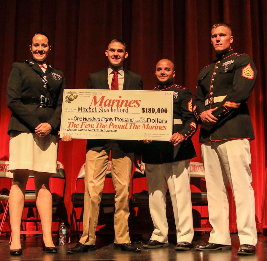 Capt. Jennifer Mozzetta, executive officer, Recruiting Station Tampa, SSgt. Kyle Hobelmann (right), station commander, Recruiting Substation Clearwater and SSgt. Nelson Aviles, canvassing recruiter, present Mitchell Shackelford, a senior at Clearwater High School, Clearwater, Fl., the Naval Reserve Officer Training Corps Marine Option Scholarship during an awards ceremony May 1, 2018. Shackelford will be granted the opportunity to serve his country as a Marine Corps officer upon completion of his degree. (Official Marine Corps photo by Sgt. Shamoon)