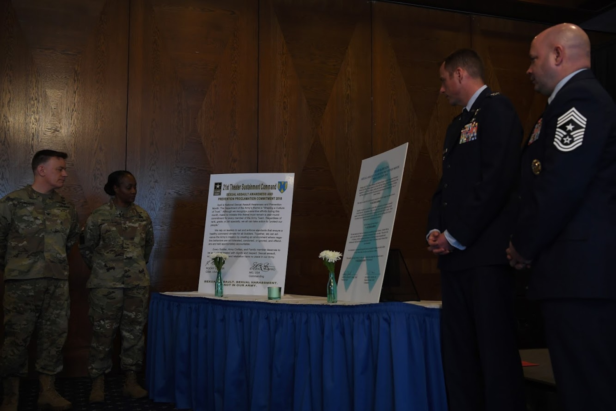 Leadership from the U.S. Army 21st Theater Sustainment Brigade and U.S. Air Force 86th Airlift Wing review the Sexual Assault Awareness and Prevention Month proclamation at Ramstein Air Base, April 12, 2018.