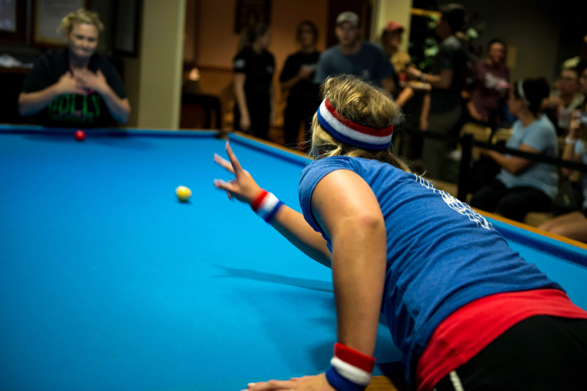 Jessica Seyfried, crud player, rolls a billiard ball at the start of a match during a spouses crud tourney, April 27, 2018, at Moody Air Force Base, Ga. The Moody spouses built the event around teamwork and comradery, giving them an opportunity to experience a long-held tradition amongst the Air Force fighter and rescue squadrons. Though the game originated in the Royal Canadian Air Force, it has since been adopted by the U.S. (U.S. Air Force photo by Airman 1st Class Erick Requadt)