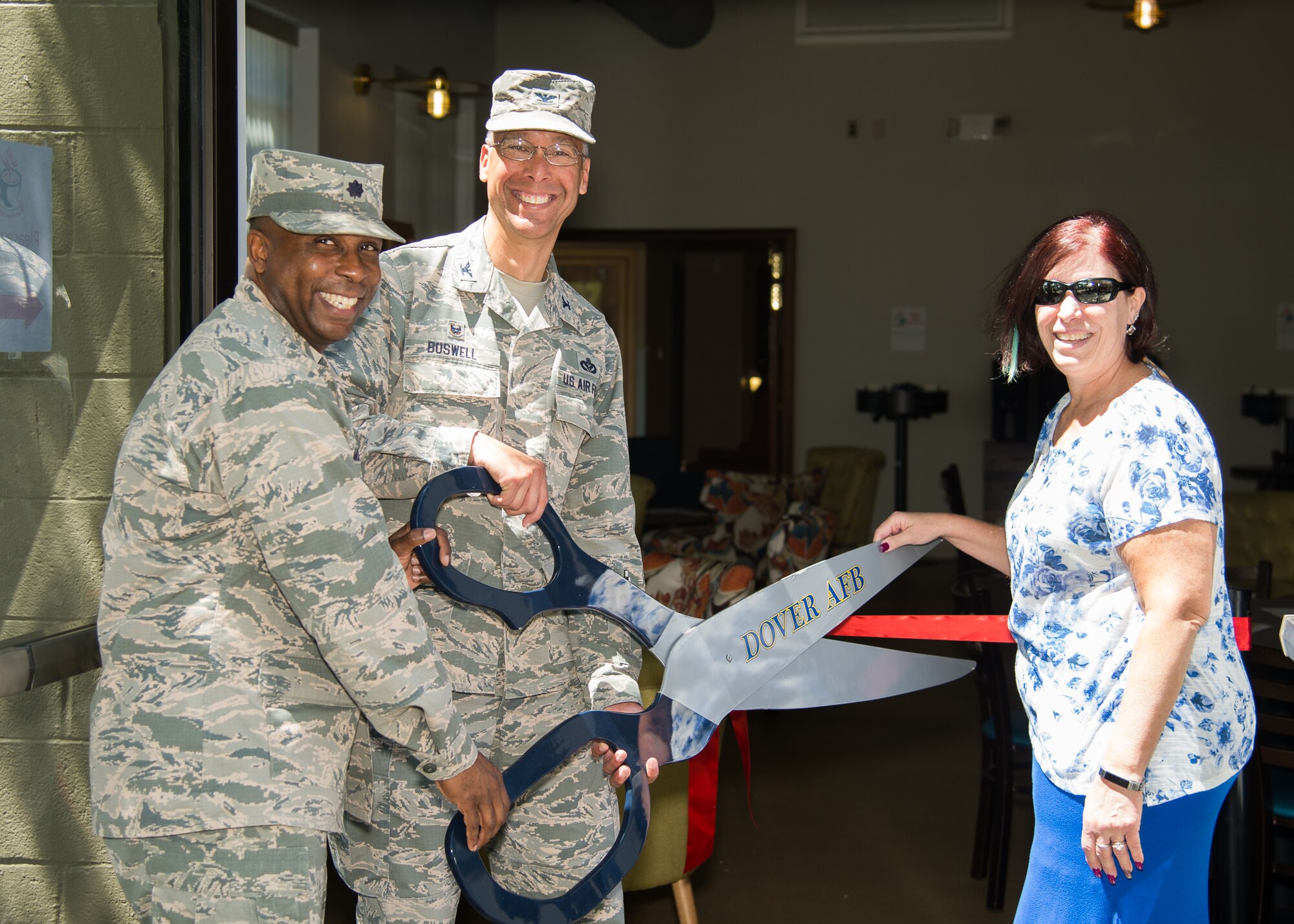 From left, Lt. Col. Arnold Mosley 436th Force Support Squadron commander, Col. Randy Boswell, 436th Mission Support Group commander and Mindy Hildebrand, 436th Force Support Squadron Community Services flight chief, at the ribbon cutting ceremony for Mugs Coffee Bar May 1, 2018, at Dover Air Force Base, Del. The coffee bar held a soft opening the week prior offering free refreshments and officially opened for business May 1. (U.S. Air Force photo by Mauricio Campino)