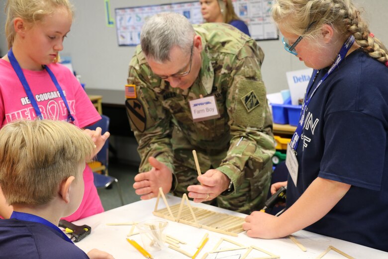 Col. Stephen Bales, U.S. Army Corps of Engineers' Middle East District commander, explains some basic engineering concepts about strength and shapes during the bridge building phase of his STARBASE Academy presentation on engineering.