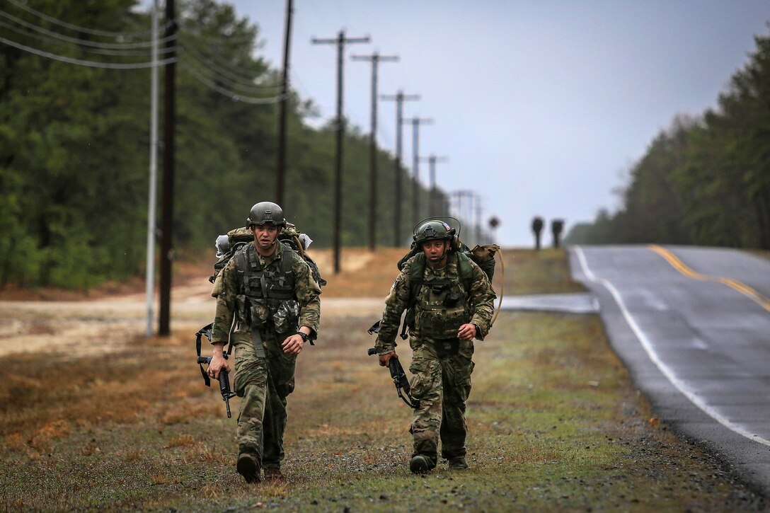 A soldier and airman arrive at the halfway point during a 12-mile ruck march.