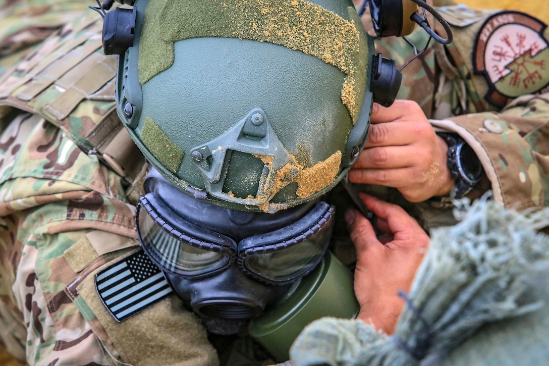 An airman dons his protective mask during the stress shoot.