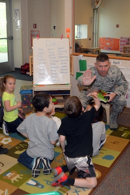 U.S. Air Force Chief Master Sgt. Patrick McMahon, senior enlisted leader of U.S. Strategic Command (USSTRATCOM), shares a high five as he reads to children at Child Development Center (CDC) I on Offutt Air Force Base, Neb., April 26, 2018. McMahon and other USSTRATCOM senior leaders read to children at the CDC in honor of Month of the Military Child, designated in April as a time to honor the sacrifices of the more than 1.7 million children of military members serving globally.