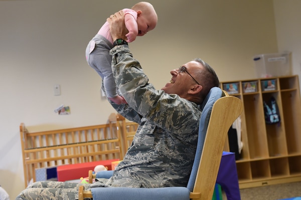 U.S. Air Force Gen. John Hyten, commander of U.S. Strategic Command (USSTRATCOM), plays with a 3-month-old baby during a visit to Child Development Center (CDC) II at Offutt Air Force Base, Neb., April 26, 2018. Hyten and other USSTRATCOM senior leaders read to children at the CDC in honor of Month of the Military Child, designated in April as a time to honor the sacrifices of the more than 1.7 million children of military members serving globally.
