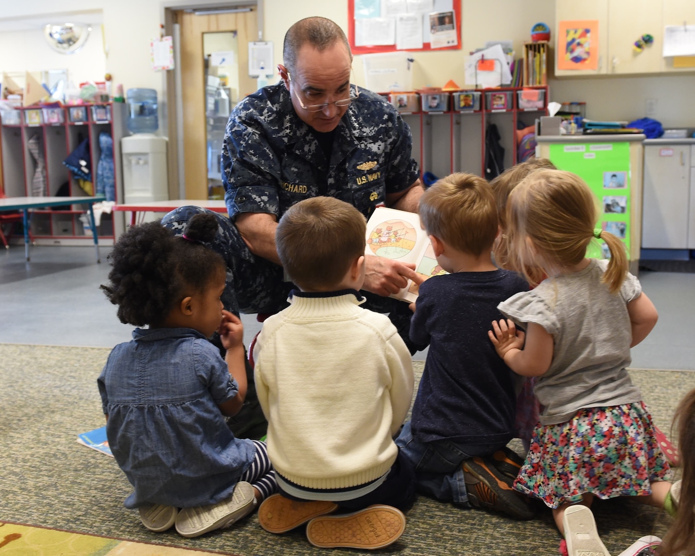 U.S. Navy Vice Adm. Charles Richard, deputy commander of U.S. Strategic Command (USSTRATCOM), reads to children during a visit to Child Development Center (CDC) II at Offutt Air Force Base, Neb., April 26, 2018. Richard and other USSTRATCOM senior leaders read to children at the CDC in honor of Month of the Military Child, designated in April as a time to honor the sacrifices of the more than 1.7 million children of military members serving globally.