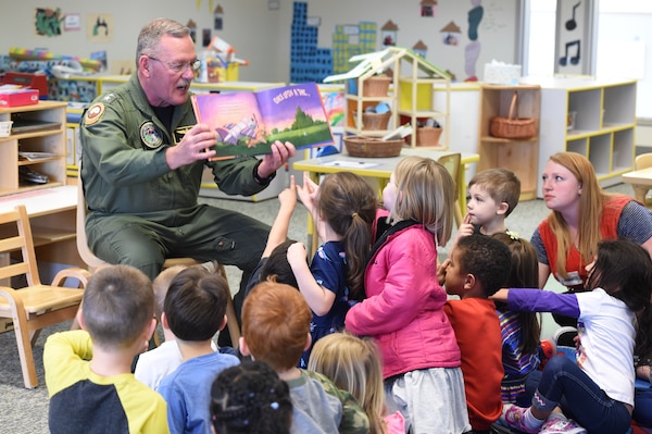 U.S. Navy Rear Admiral Daniel H. Fillion, director of U.S. Strategic Command (USSTRATCOM) Global Operations, reads to children during a visit to Child Development Center (CDC) II at Offutt Air Force Base, Neb., April 26, 2018. Fillion and other USSTRATCOM senior leaders read to children at the CDC in honor of Month of the Military Child, designated in April as a time to honor the sacrifices of the more than 1.7 million children of military members serving globally.