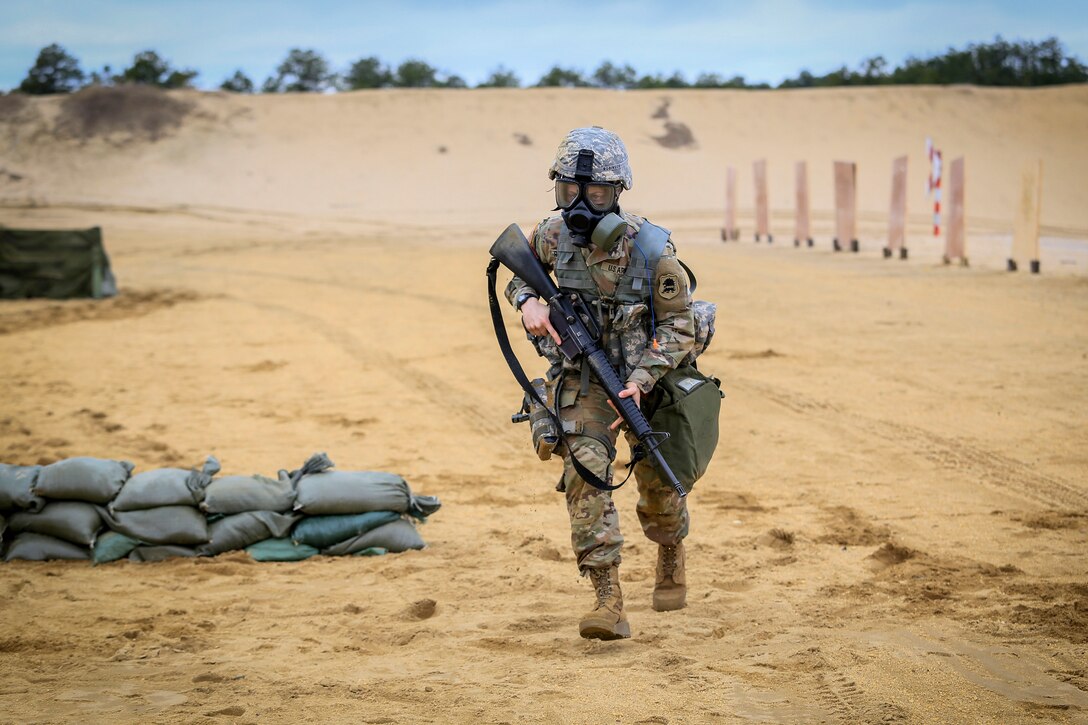 A soldier runs quickly during the stress shoot.