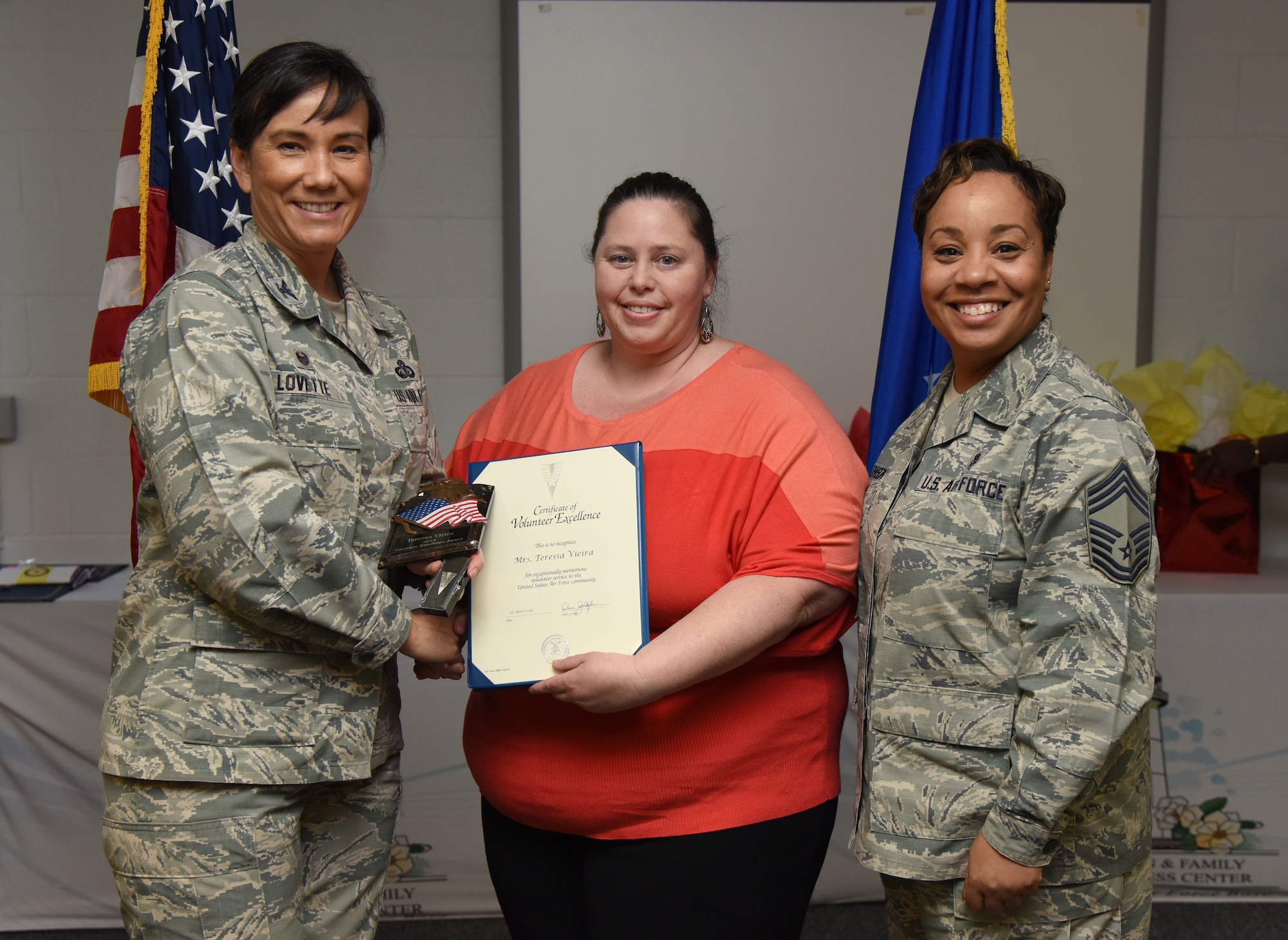 U.S. Air Force Col. Debra Lovette, 81st Training Wing commander, and Chief Master Sgt. Tanya Johnson, 81st Diagnostic and Therapeutics Squadron superintendent, presents Teressa Vieira, spouse of Jon Vieira, 81st Logistics Readiness Squadron motor vehicle operator, with a Volunteer Excellence certificate during the 2018 Volunteer Appreciation Ceremony at the Sablich Center at Keesler Air Force Base, Mississippi, April 26, 2018. The event recognized Keesler personnel, family members and retirees for their volunteer service in 2017. (U.S. Air Force photo by Kemberly Groue)