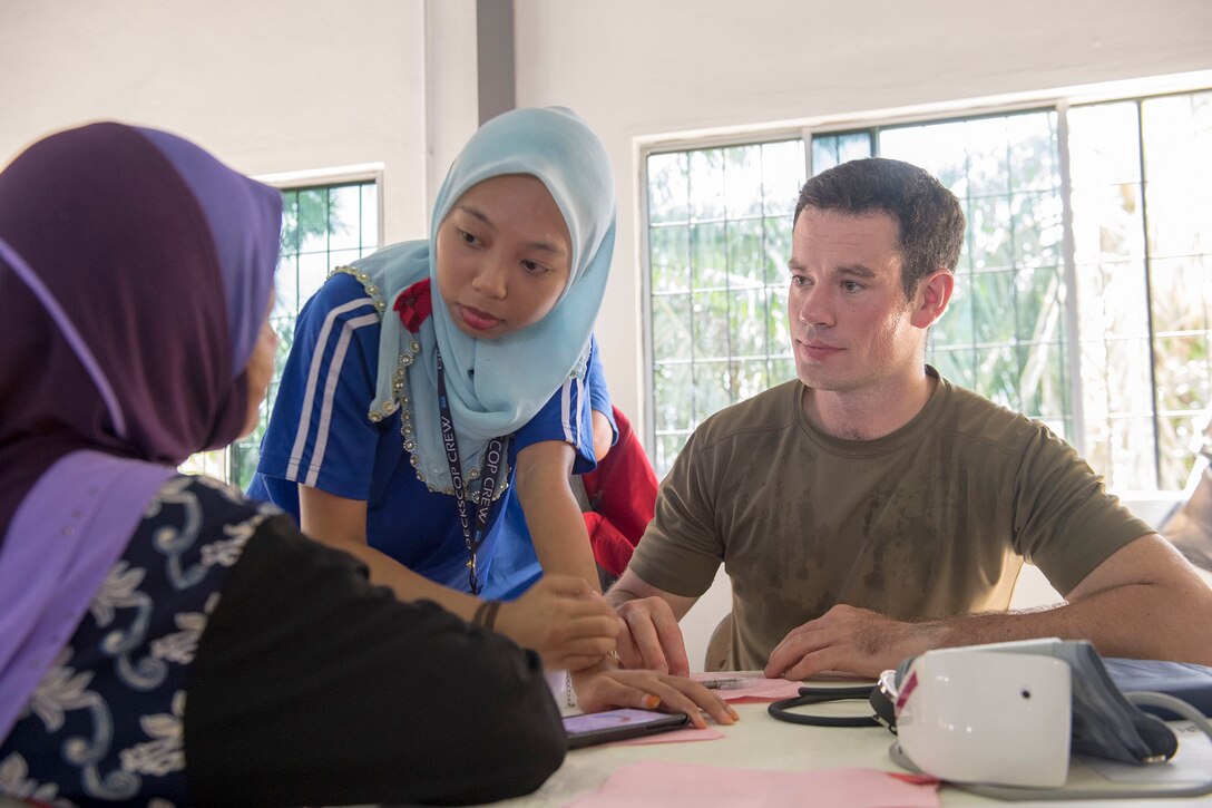 A translator conveys special medical instructions to a patient.