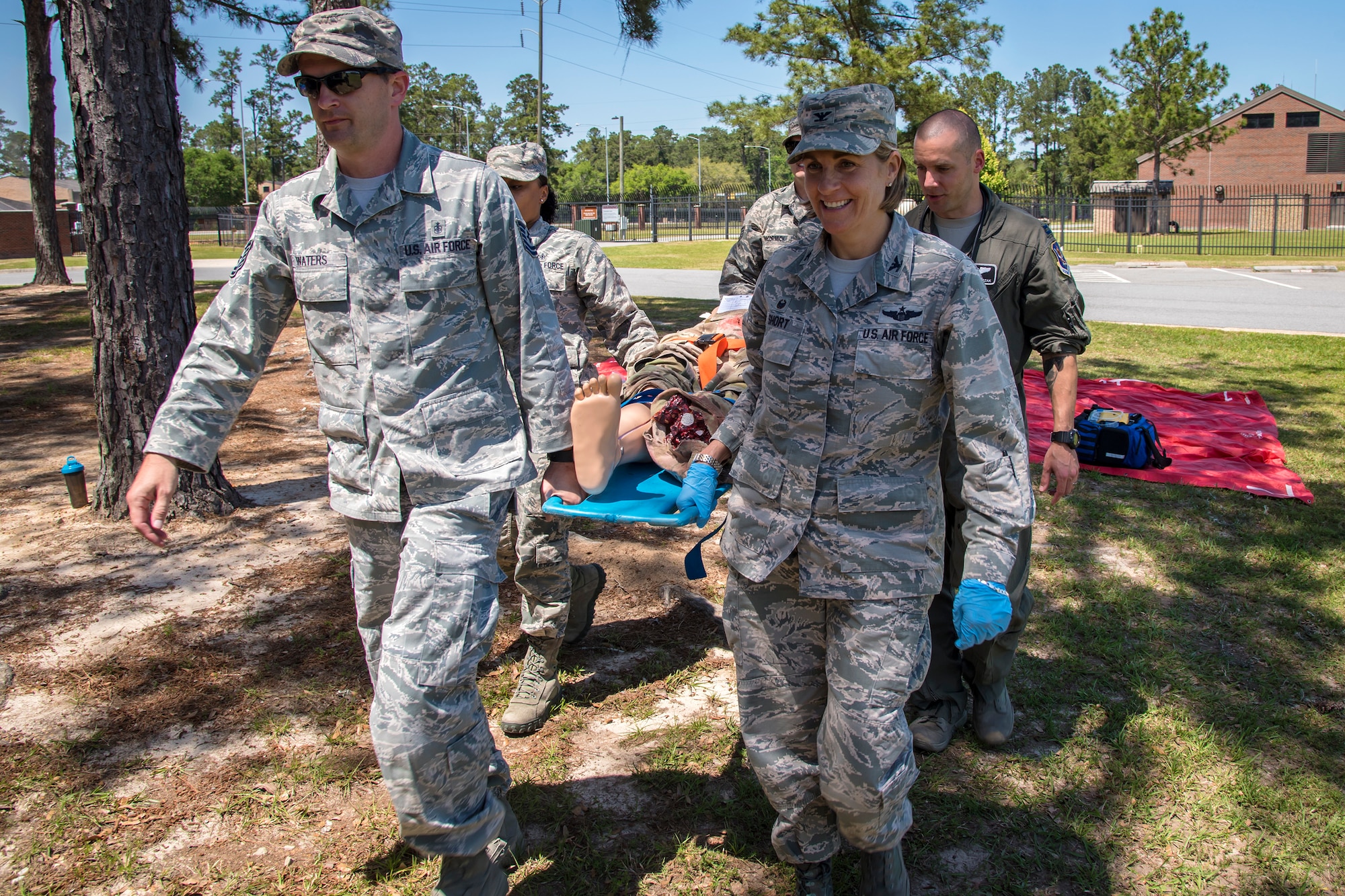 Col. Jennifer Short, right, 23d Wing commander, along with Airmen from the 23d Medical Group (MDG), carry a mannequin, April 30, 2018, at Moody Air Force Base, Ga. Short toured the 23d MDG to gain a better understanding of their overall mission, capabilities, and comprehensive duties, and was able to experience the day-to-day operations of the various units within the 23d MDG, ranging from bioenvironmental to ambulatory care. (U.S. Air Force photo by Airman 1st Class Eugene Oliver)