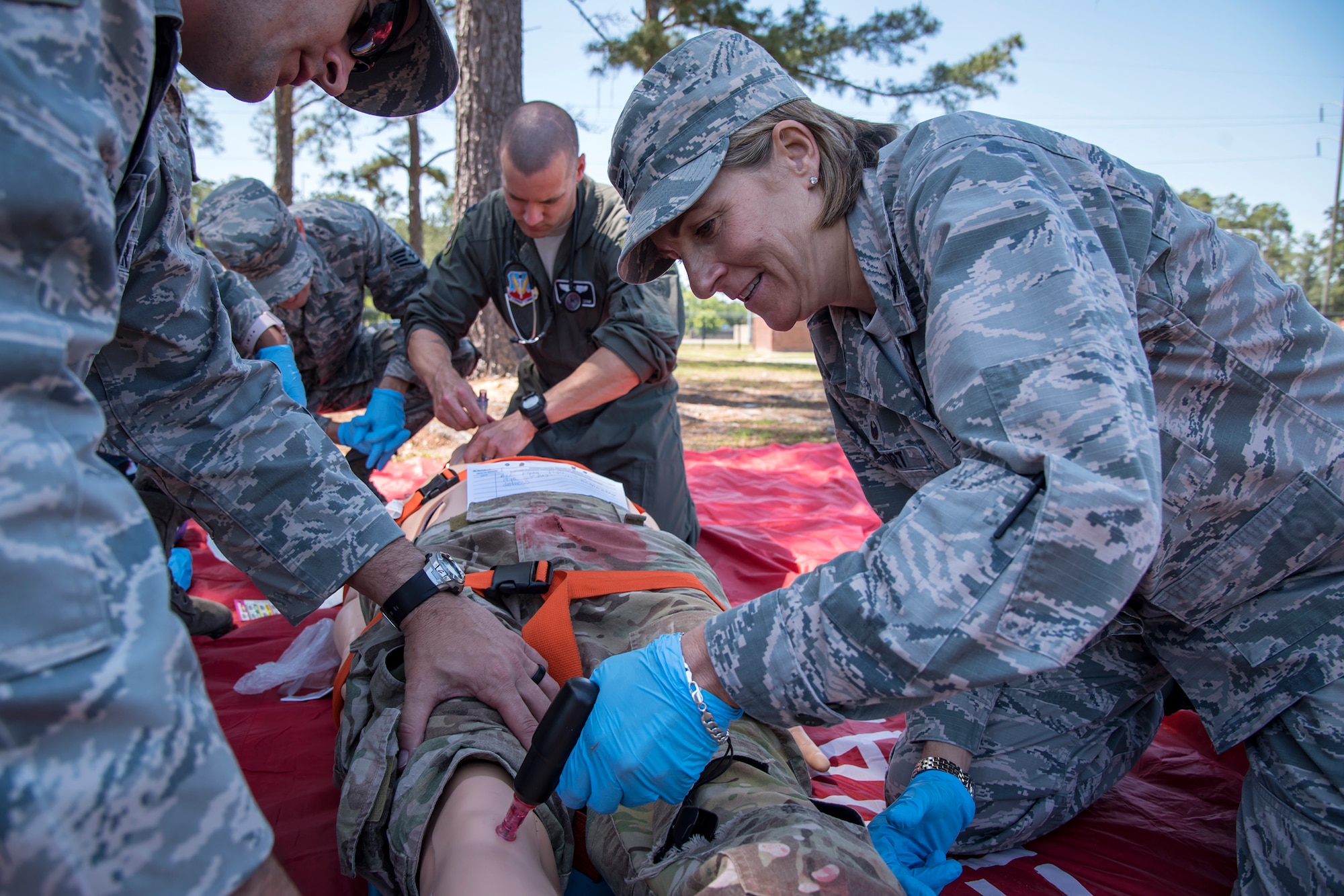 Col. Jennifer Short, right, 23d Wing commander, creates an intravenous incision into the leg of a mannequin, April 30, 2018, at Moody Air Force Base, Ga. Short toured the 23d Medical Group (MDG) to gain a better understanding of their overall mission, capabilities, and comprehensive duties, and was able to experience the day-to-day operations of the various units within the 23d MDG, ranging from bioenvironmental to ambulatory care. (U.S. Air Force photo by Airman 1st Class Eugene Oliver)