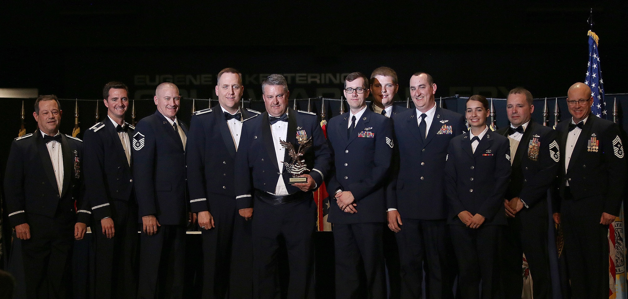 Members of the 89th Airlift Squadron accept the 445th Airlift Wing 2017 Squadron of the Year Award from Col. Adam Willis, 445th Airlift Wing commander, and Chief Master Sgt. Paul Stewart, 445 AW command chief, during the wing's annual awards banquet held April 7, 2018 at the National Museum of the U.S. Air Force