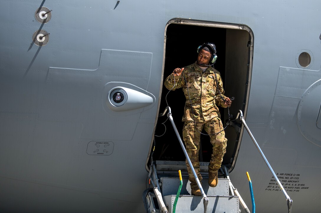 An airman completes preflight checks on a C-17 Globemaster III.