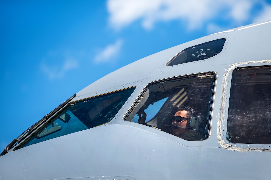 A pilot completes preflight checks on a C-17 Globemaster III.