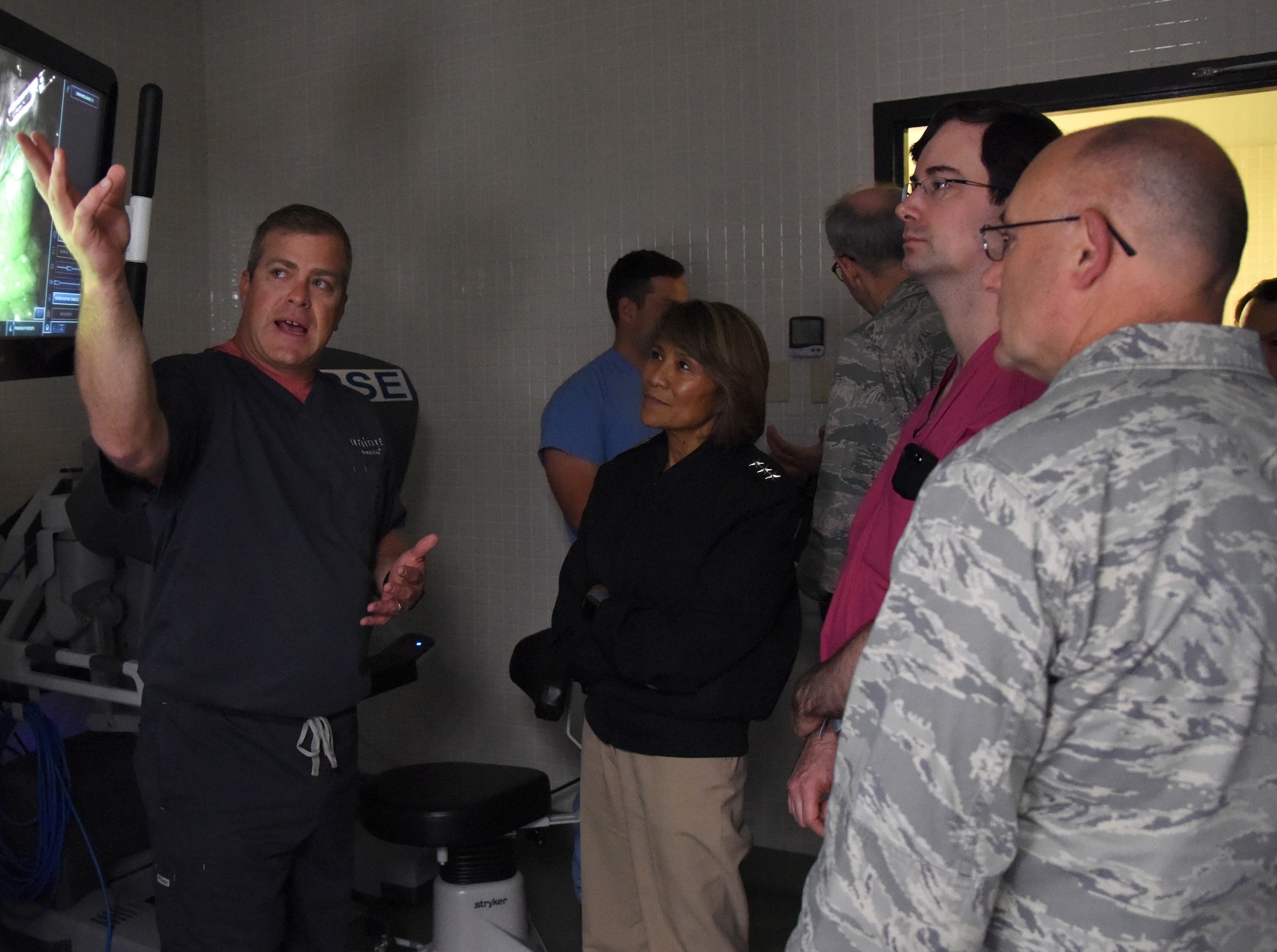 Greg Street, Intuitive Surgical instructor, left, briefs U.S. Navy Vice Adm. Raquel Bono, Defense Health Agency director, on the capabilities of robotics surgery at the Clinical Research Lab during a site visit at Keesler Air Force Base, Mississippi, April 27, 2018. The purpose of the visit was to get oriented with base operations and the Keesler Medical Center. The visit also included an office call with 2nd Air Force leadership and tours of Radiology Oncology and the newly renovated 81st Dental Squadron clinic. (U.S. Air Force photo by Kemberly Groue)