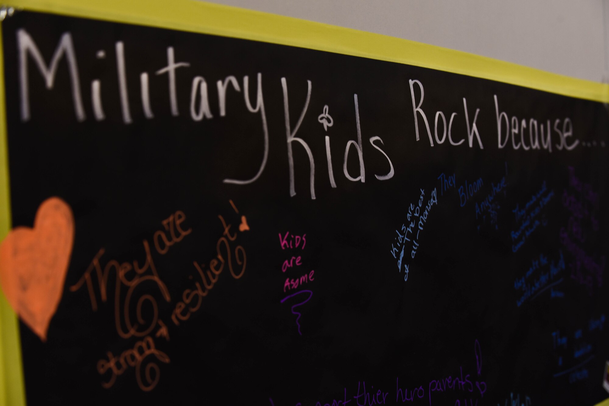 A poster hangs for military kids to write why they ‘rock’ during the Month of the Military Child Spring Bash April 27, 2018, on F.E. Warren Air Force Base, Wyo. There were various events and activities for the children to take part in, from corn hole to face painting. The 90th Force Support Squadron held this spring bash to celebrate the children of military members and what they experience.  (U.S. Air Force photo by Airman 1st Class Braydon Williams)
