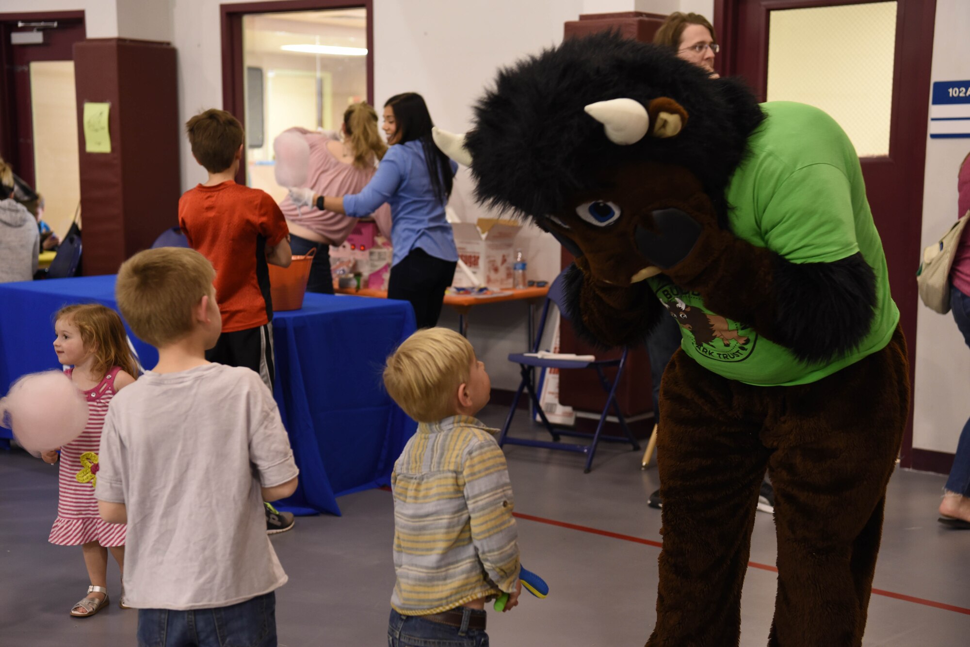 Children speak with Buddy Bison during the Month of the Military Child Spring Bash April 27, 2018, on F.E. Warren Air Force Base, Wyo. Buddy Bison is a program that allows children and families to participate in activities such as camping, canoeing, fishing, and hiking while exploring local state and national parks, with a goal to encourage children to be good stewards to the parks. The 90th Force Support Squadron held this spring bash to celebrate the children of military members and what they experience.  (U.S. Air Force photo by Airman 1st Class Braydon Williams)