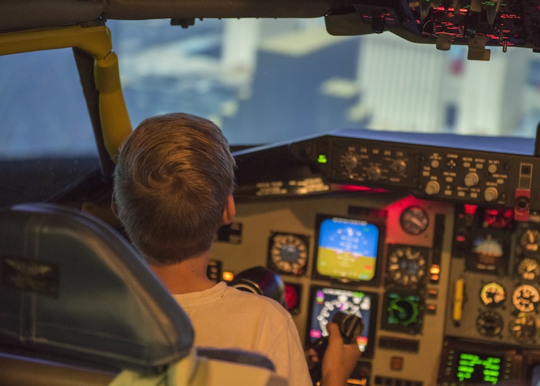 Saim Smith, son of U.S. Air Force Tech. Sgt. Mark Smith, a flight chief of military training flight assigned to the 97th Training Squadron, pilots a KC-135 Stratotanker simulator, April 26, 2018, at Altus Air Force Base, Okla.