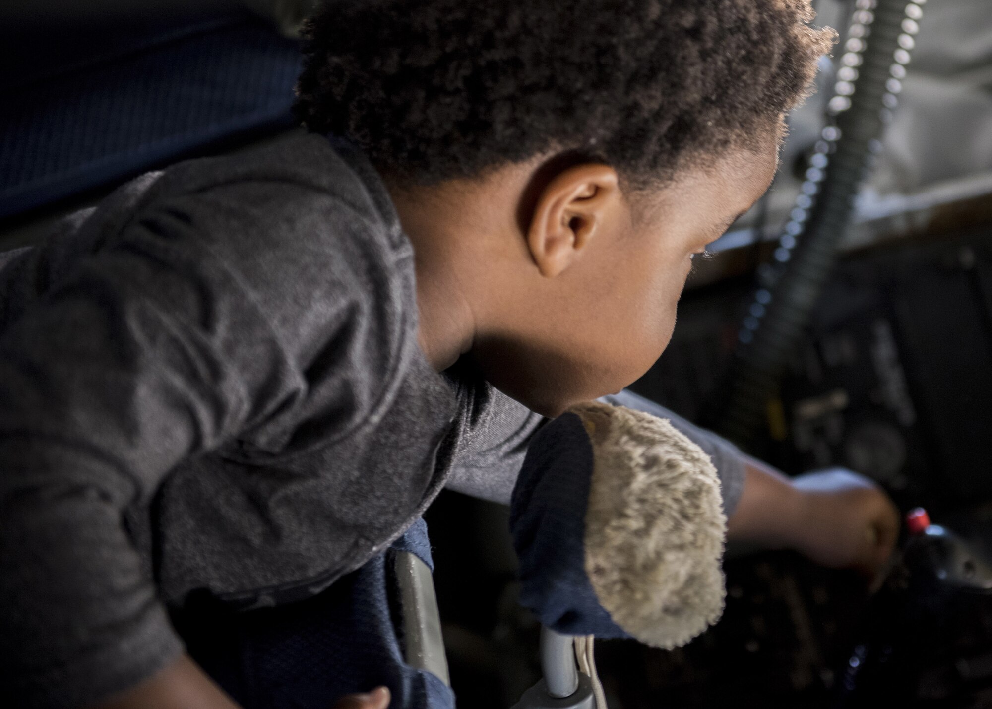 Khai Mahan, son of U.S. Air Force Staff Sgt. Liahna Childs, an instructor boom operator assigned to the 54th Air Refueling Squadron, lies in the boom pod of a KC-135 Stratotanker, April 26, 2018, at Altus Air Force Base, Okla.