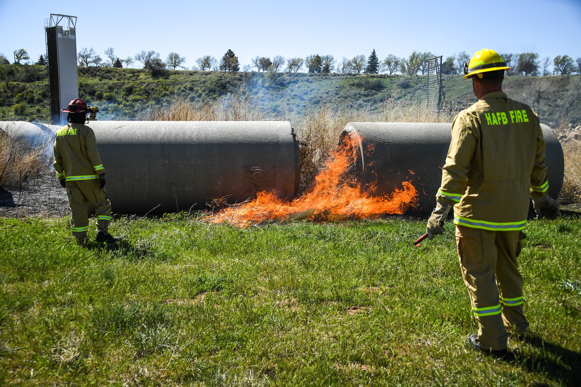 Firefighters conduct a controlled burn on a section of the Base Operations and Readiness Training Area April 27, 2018, at Hill Air Force Base, Utah. The prescribed burn targeted overgrown vegetation around structures used by the department’s technical rescue program members and other partner emergency-services for training. (U.S. Air Force photo by R. Nial Bradshaw)