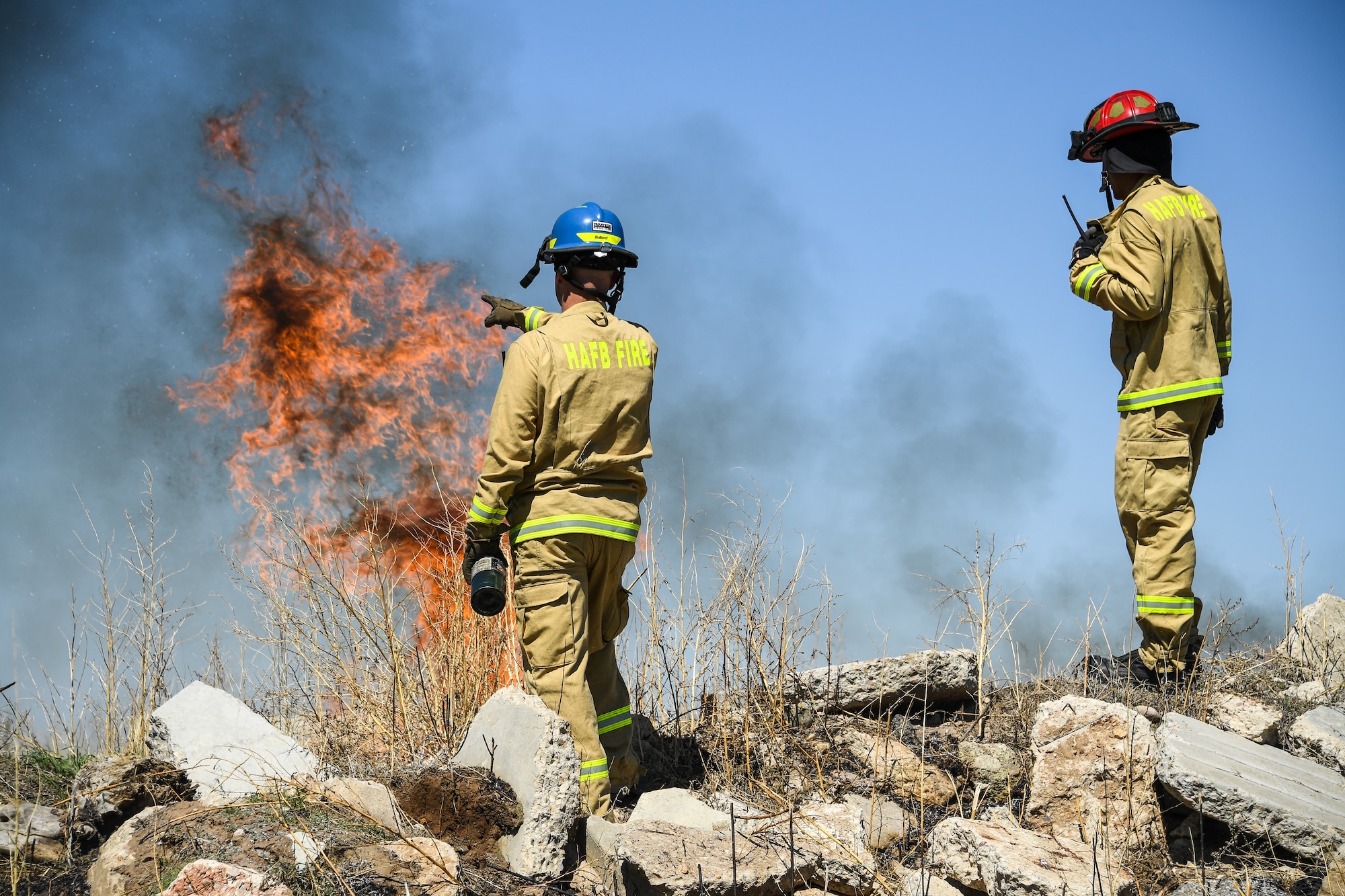 Firefighters conduct a controlled burn on a section of the Base Operations and Readiness Training Area April 27, 2018, at Hill Air Force Base, Utah. The prescribed burn targeted overgrown vegetation around structures used by the department’s technical rescue program members and other partner emergency-services for training. (U.S. Air Force photo by R. Nial Bradshaw)