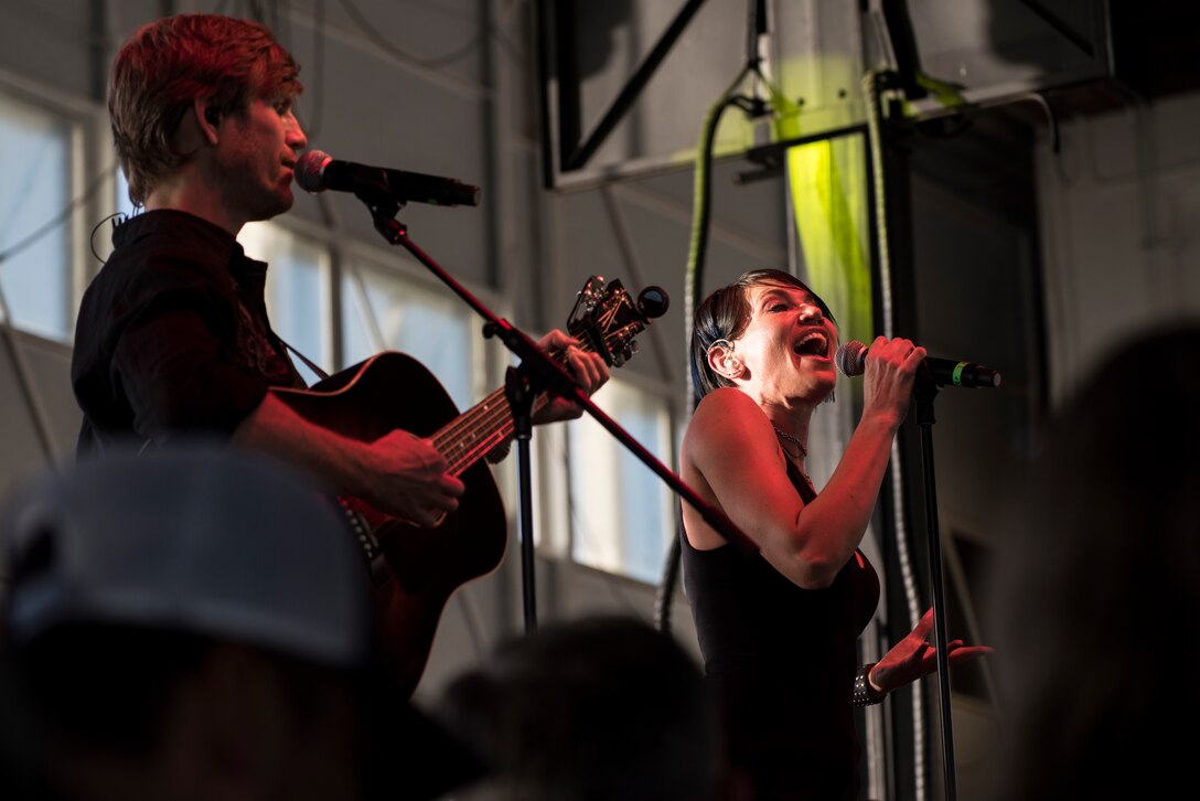 A photo of Jeff Vezain, Lt. Dan Band vocalist and acoustic guitarist, and Molly Callinan, Lt. Dan Band vocalist, perform a song during a concert, April 26, 2018, at Mountain Home Air Force Base, Idaho. The concert performed by Gary Sinise and the Lt. Dan Band was their first at Mountain Home AFB. (U.S. Air Force Photo by Airman 1st Class Hailey Bivens)