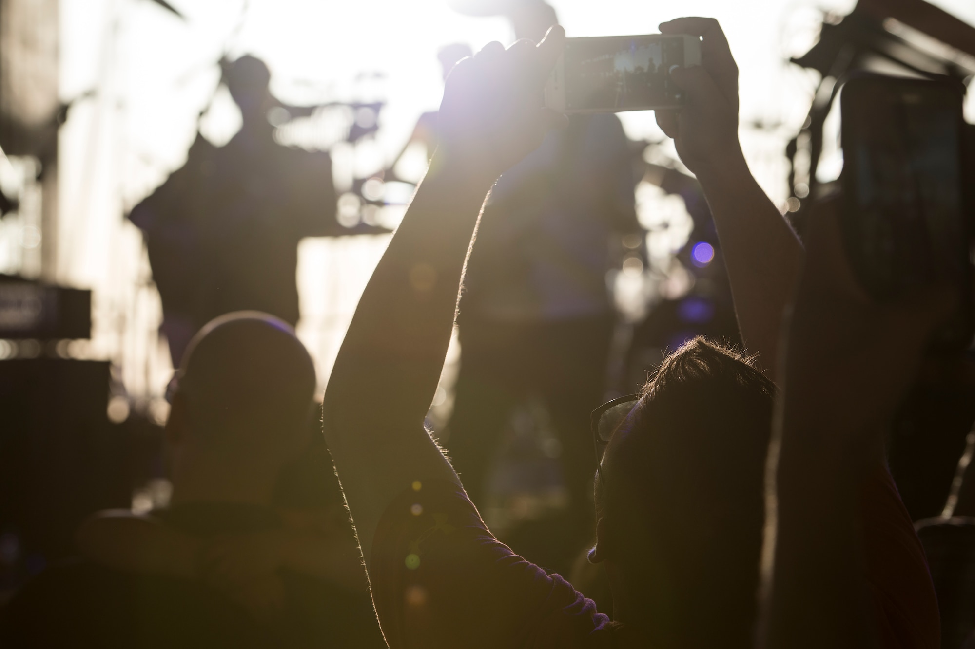 A photo of a concert attendee takes a photo of the Lt. Dan Band, April 26, 2018, at Mountain Home Air Force Base, Idaho. The Lt. Dan Band is a function supported by the Gary Sinise Foundation. (U.S. Air Force Photo by Airman 1st Class JaNae Capuno)