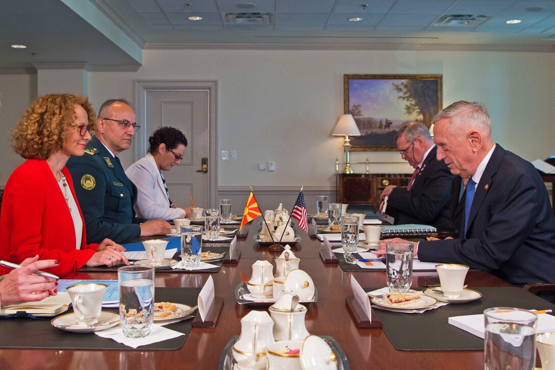 Defense Secretary James N. Mattis sits at a rectangular table and talks with his Macedonian counterpart and other officials.