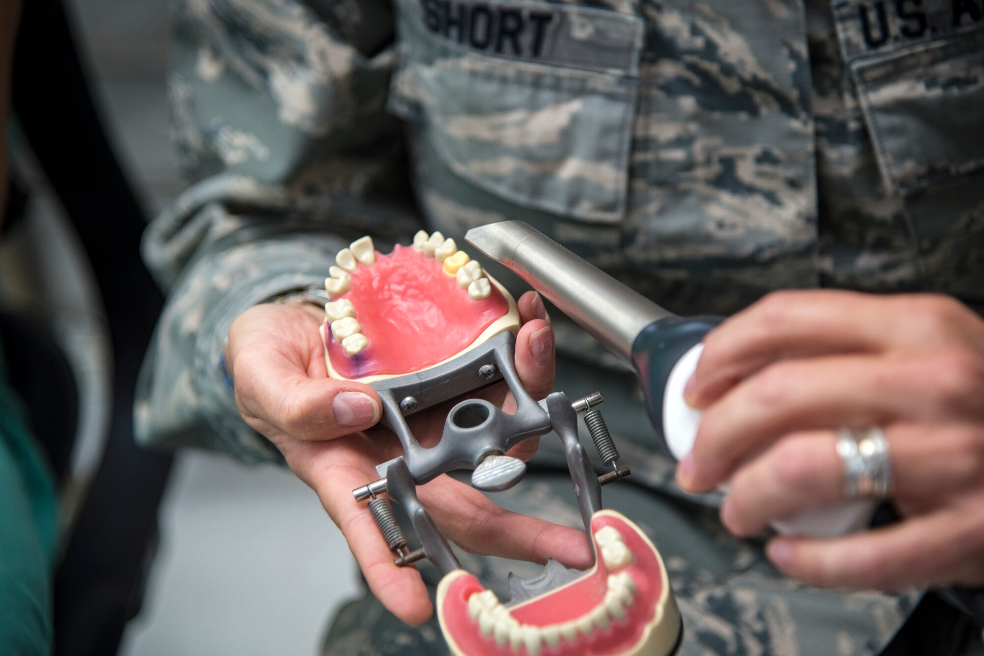 U.S. Air Force Col. Jennifer Short, 23d Wing commander, flashes a light on a jaw model at Moody Air Force Base, Ga., April 30, 2018. Short toured the 23d Medical Group (MDG) to gain a better understanding of their overall mission, capabilities, and comprehensive duties, and was able to experience the day-to-day operations of the various units within the 23d MDG, ranging from bioenvironmental to ambulatory care. (U.S. Air Force photo by Airman 1st Class Eugene Oliver)