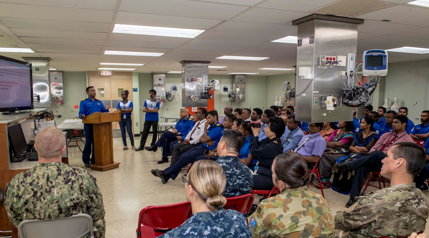 Capt. N.H. Karandeniya, oral surgeon in the Sri Lankan Navy, speaks during a dental subject matter expert exchange (SMEE) in support of Pacific Partnership 2018 (PP18) aboard Military Sealift Command hospital ship USNS Mercy (T-AH 19). PP18's mission is to work collectively with host and partner nations to enhance regional interoperability and disaster response capabilities, increase stability and security in the region, and foster new and enduring friendships across the Indo-Pacific Region. Pacific Partnership, now in its 13th iteration, is the largest annual multinational humanitarian assistance and disaster relief preparedness mission conducted in the Indo-Pacific.