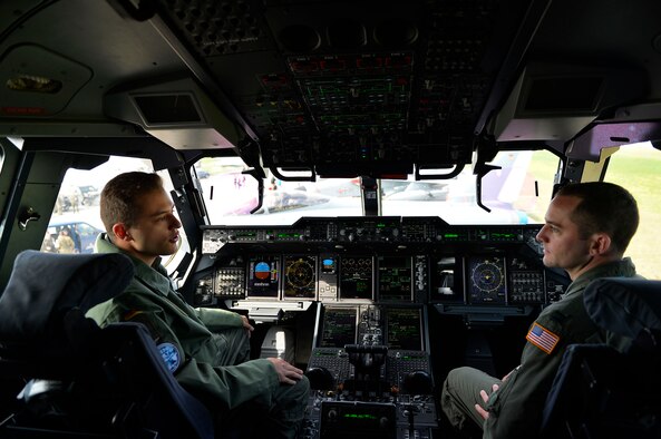 German Air Force 1st Lt. Felix, an A400M Atlas co-pilot, left, discusses the capabilities of his aircraft with U.S. Air Force Capt. Tim Vedra, 37th Airlift Squadron C-130J Super Hercules instructor pilot, in Berlin, Germany, April 27, 2018. U.S. and German Airmen shared knowledge with each other concerning their respective airframes during the 2018 Berlin Air and Trade Show. (U.S. Air Force photo by Senior Airman Joshua Magbanua)