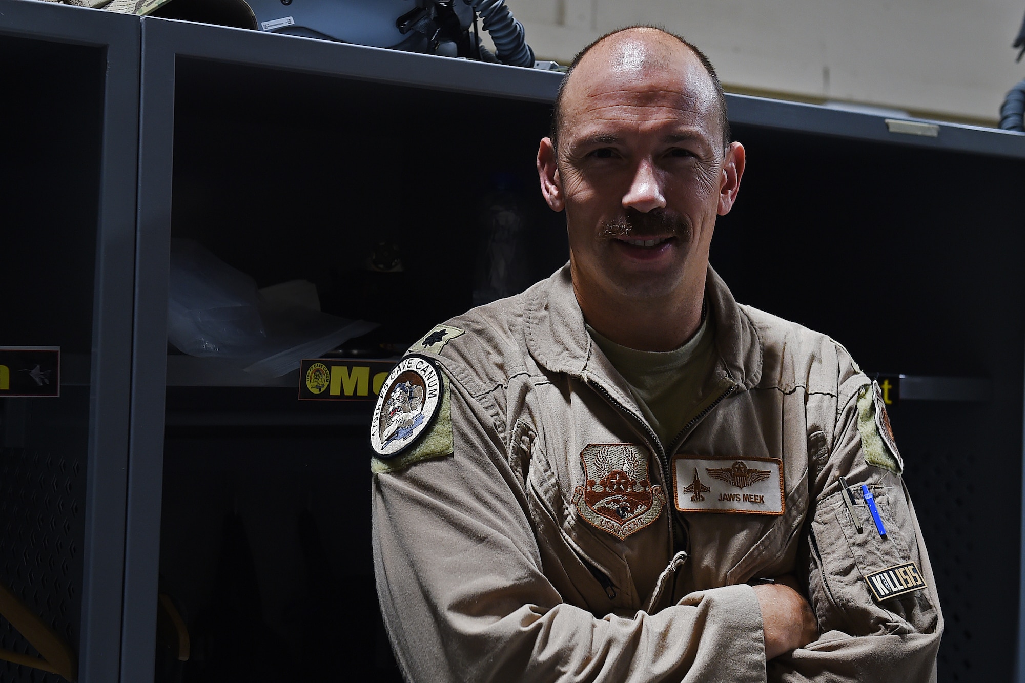 Lt. Col. Meek poses for a photo in front of lockers