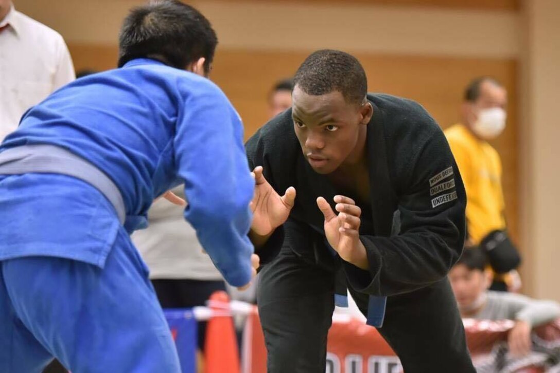 Jiujitsu competitors square up during a match.