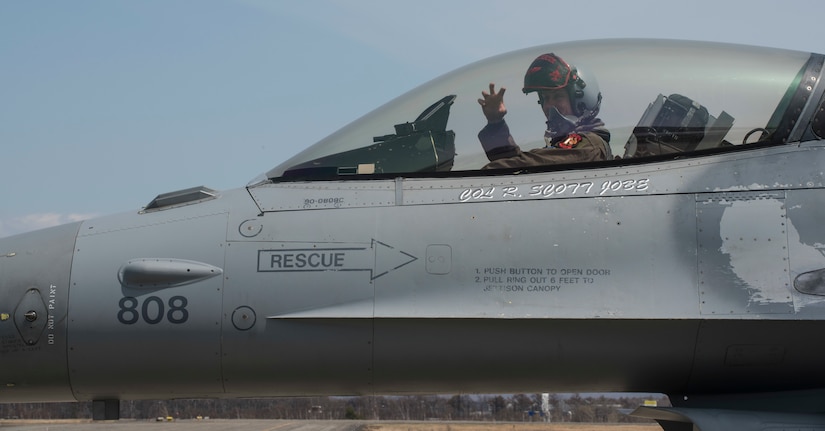 U.S. airman sits in F-16 cockpit.