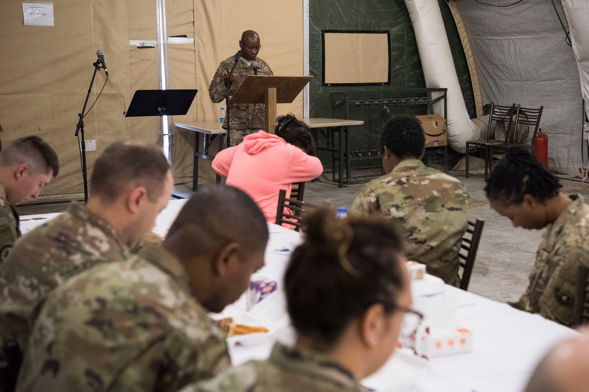 Capt. Brendan Mbagwu, 332nd Air Expeditionary Wing chaplain, recites a prayer during a breakfast the 332nd Air Expeditionary Wing held in observance of National Day of Prayer May 3, 2018, at an undisclosed location in Southwest Asia.