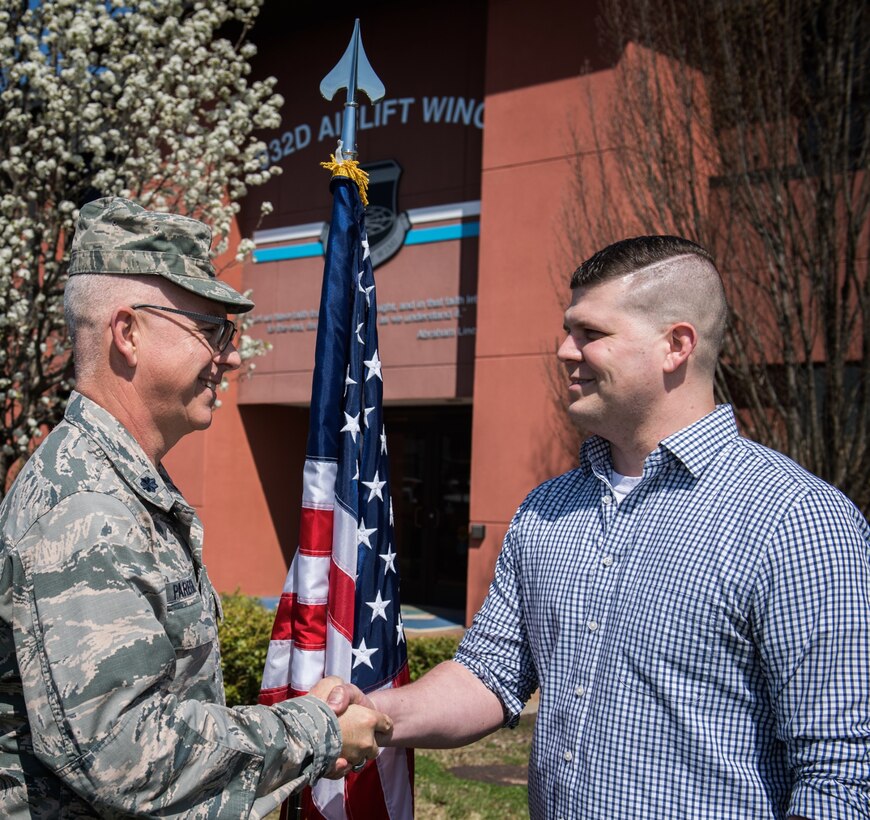 Lt. Col. Stan Paregien, 932nd Chief of Public Affairs, congratulates one of the wing's newest recruits, Ryan Hill, after he recites the oath of enlistment.  Hill is  going into the medical area, following his enlistment into the 932nd Airlift Wing. He raised his right hand and enlisted on a sunny day, coming into the Air Force Reserve Command and the 932nd Airlift Wing on April 17, 2018, at Scott Air Force Base.  His recruiter, Master Sgt. Tabetha Coley, works the St. Peters side of the river in Missouri.  Those who want to refer a friend to the unit can call 1-800-257-1212.  (U.S. Air Force photo by Christopher Parr)