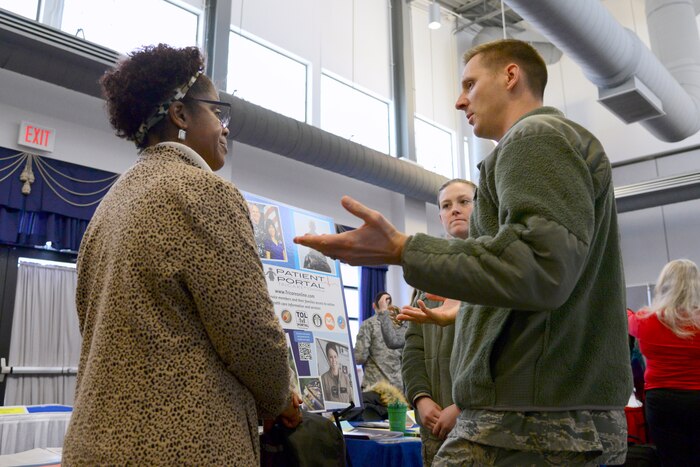 Two airmen speak to a civilian.