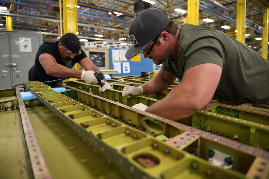 Sheet metal mechanics Alex Turbyfill, right, and Gilbert Martinez, assigned to 533rd Commodities Maintenance Squadron, work on an F-16 wing April 26, 2018, at Hill Air Force Base, Utah. The 533rd is performing structural-strengthening modifications as part of the F-16 Service Life Extension Program, or SLEP, that will keep the jets flying for decades. (U.S. Air Force photo by R. Nial Bradshaw)
