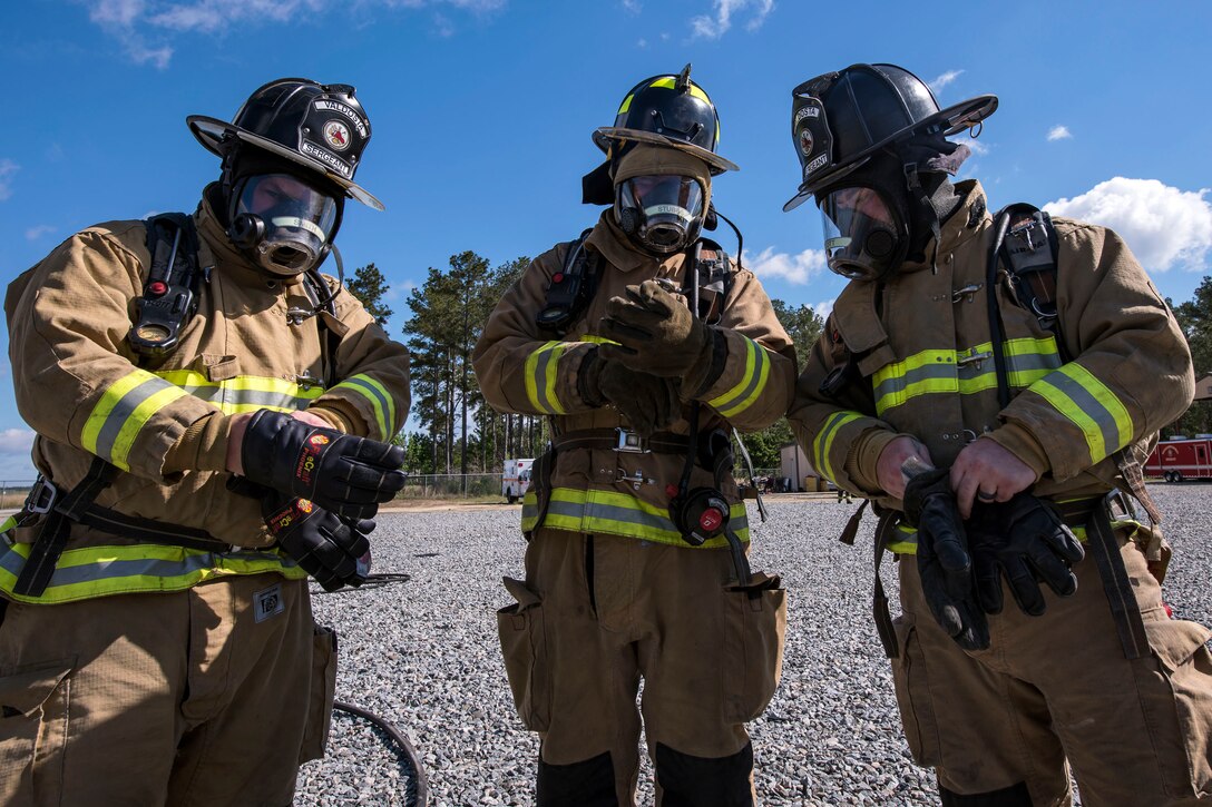 Firefighters from the squadron and firefighters from the Valdosta Fire Department put on their equipment before a training exercise.