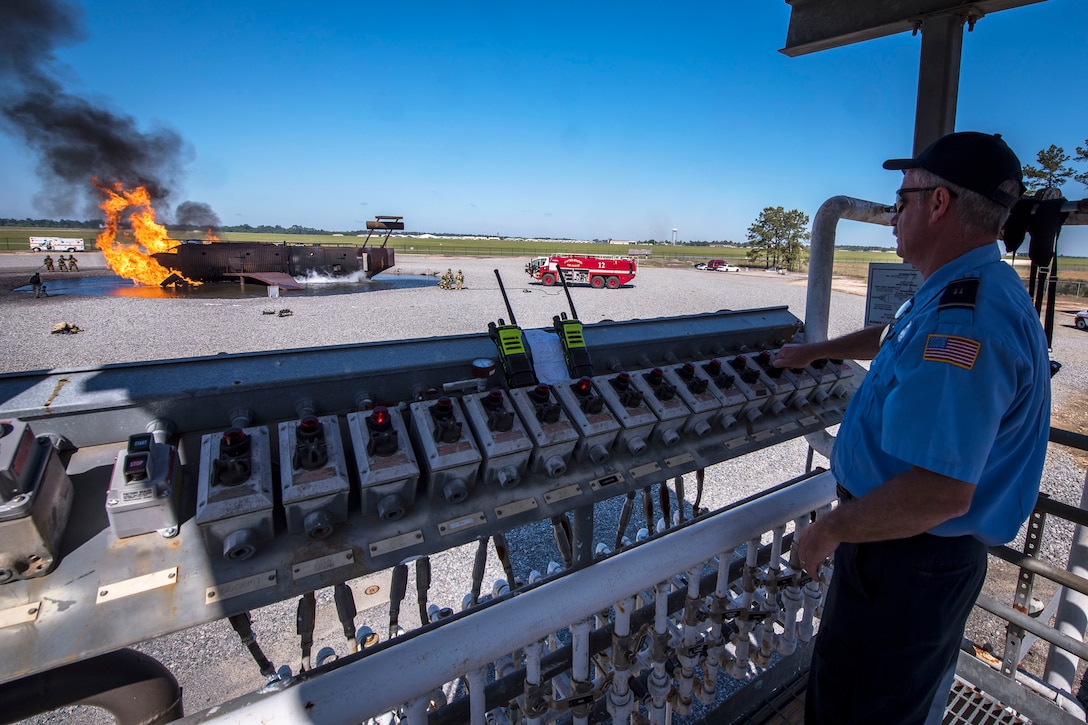 A fire crew chief operated an ignition control panel.