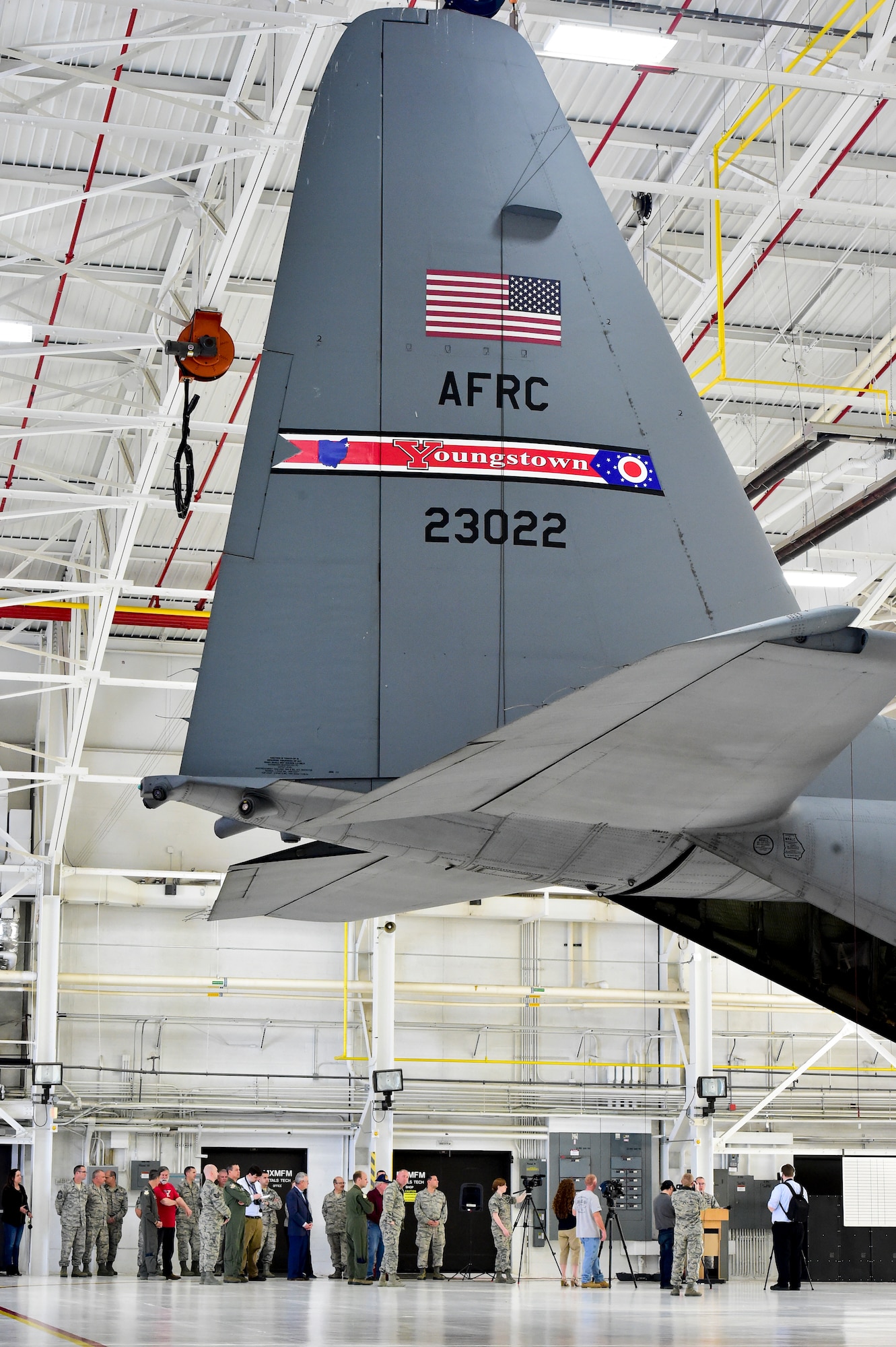 Youngstown State University President Jim Tressel and 910th Airlift Wing Commander Dan Sarachene talk near a pair of C-130H Hercules aircraft here, May 3, 2018, after a ceremony to unveil a new aircraft tail flash.